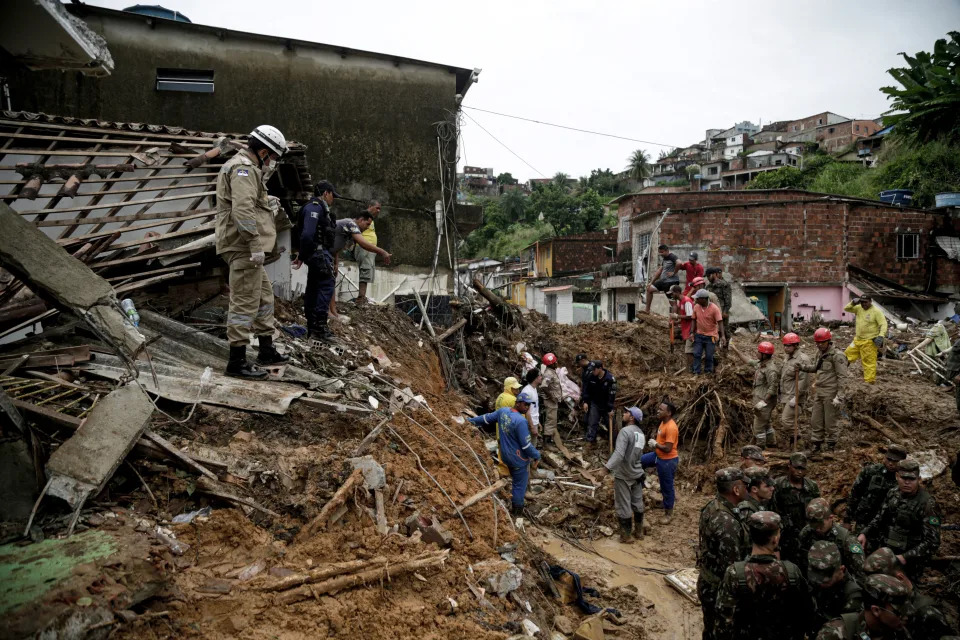 Soldiers, firefighters and residents search for victims a day after a landslide in the community Jardim Monte Verde, Ibura neighbourhood, in Recife, Pernambuco State, Brazil, on May 29, 2022. - Torrential rains that have plagued Brazil's northeastern Pernambuco state since Tuesday have left at least 34 dead, 29 of which occurred over the last 24 hours, according to the latest official update. (Photo by Brenda ALCANTARA / AFP) (Photo by BRENDA ALCANTARA/AFP via Getty Images)