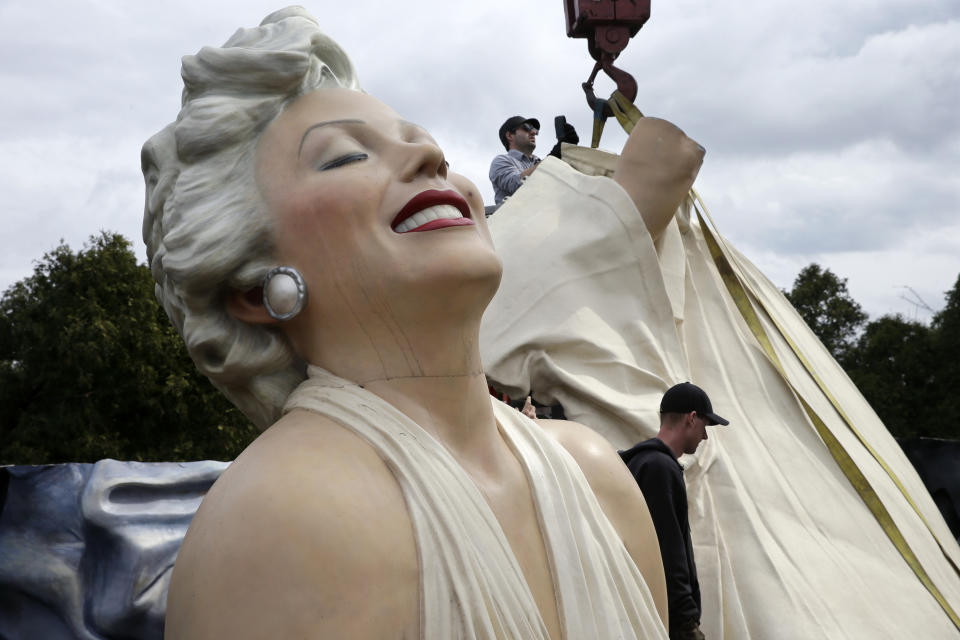 Workers prepare to lift parts of a 26-foot-tall, 34,000-pound statue named "Forever Marilyn" in Hamilton, N.J., Tuesday, April 8, 2014. The sculpture depicting Marilyn Monroe in her memorable billowing skirt pose from the "The Seven Year Itch" is part of an exhibit honoring its designer, Seward Johnson. (AP Photo/Mel Evans)