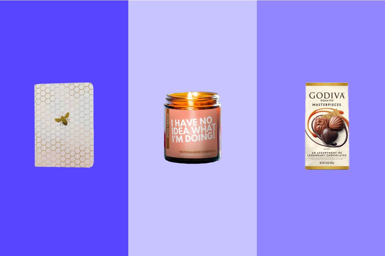 a notebook, comedic candle, and bag of Godiva chocolates as ideas for filling a Christmas gift basket