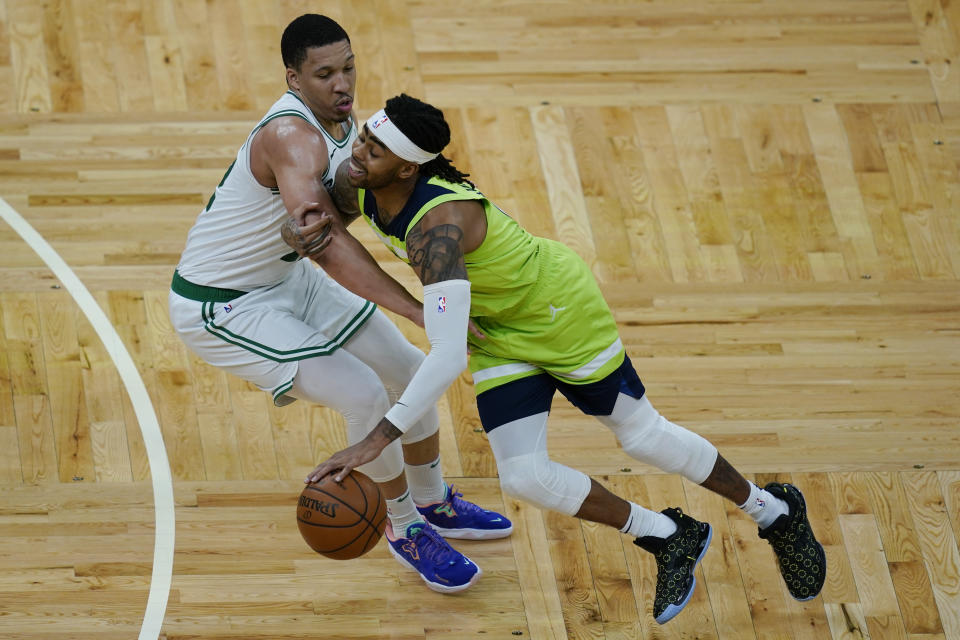 Minnesota Timberwolves guard D'Angelo Russell, right, drives against Boston Celtics forward Grant Williams in the fourth quarter of an NBA basketball game, Friday, April 9, 2021, in Boston. (AP Photo/Elise Amendola)