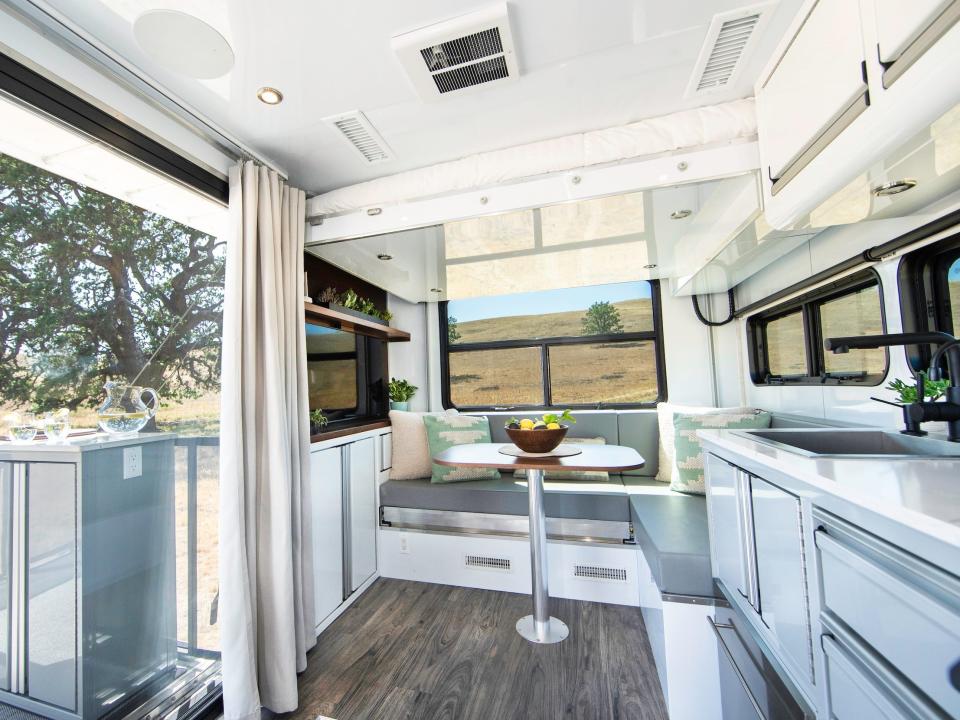 A kitchen and living room next to a patio.