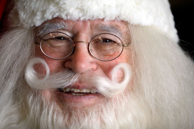 Fred Honerkamp, smiles while wearing his Santa Claus outfit as he prepares to visit Jerusalem's Old City together with a group of Santa Clauses from around the world, at a hotel in Jerusalem