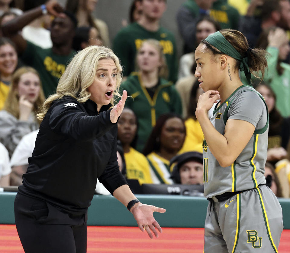 Baylor head coach Nicki Collen, left, speaks with guard Jada Walker during a break with Texas in the first half of an NCAA college basketball game, Thursday, Feb. 1, 2024, in Waco, Texas. (Rod Aydelotte/Waco Tribune-Herald via AP)