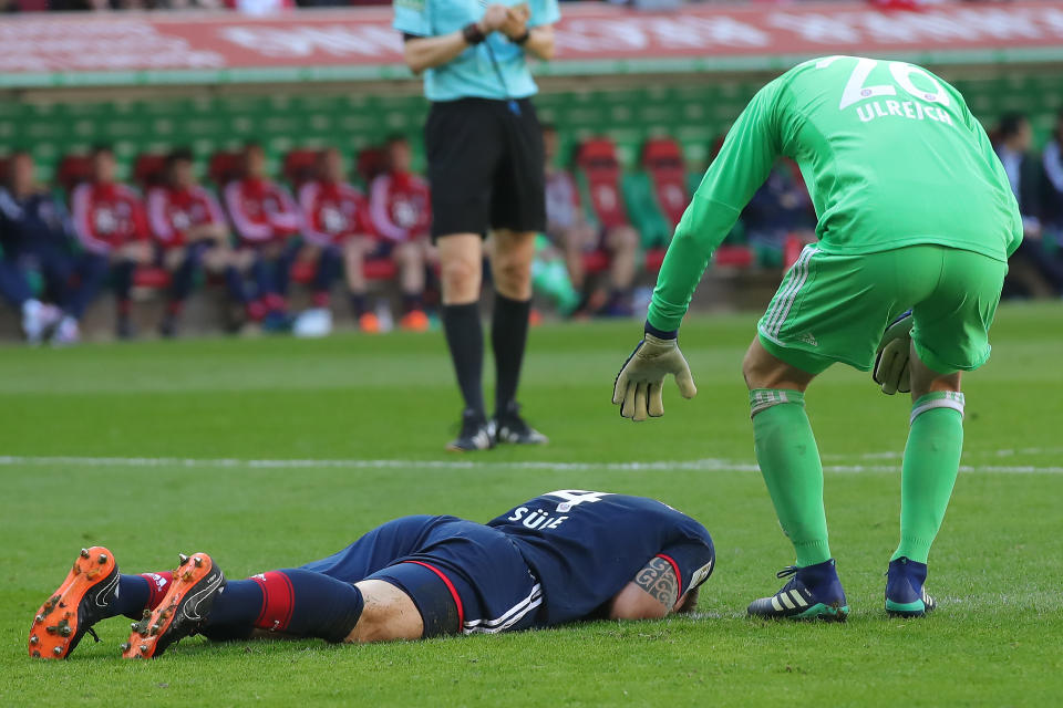 Bayern Munich defender Niklas Sule lies on the field after scoring his own goal. (Getty)