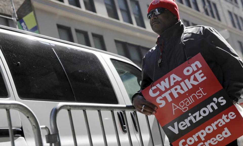 A member of the Communications Workers of America pickets in front of Verizon corporate offices during a 2016 strike in New York City.
