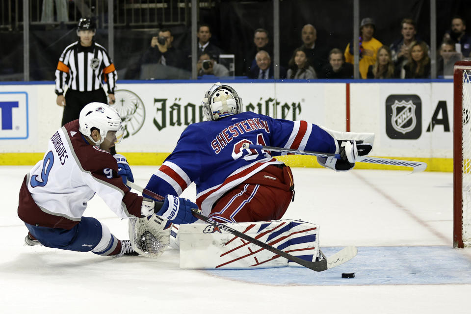 Colorado Avalanche center Evan Rodrigues scores a goal past New York Rangers goaltender Igor Shesterkin during a shootout in an NHL hockey game Tuesday, Oct. 25, 2022, in New York. The Avalanche won 3-2 in a shootout. (AP Photo/Adam Hunger)