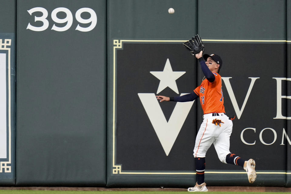 Houston Astros center fielder Mauricio Dubon catches a fly ball hit by Seattle Mariners' Ty France during the third inning of a baseball game Friday, Aug. 18, 2023, in Houston. (AP Photo/Eric Christian Smith)