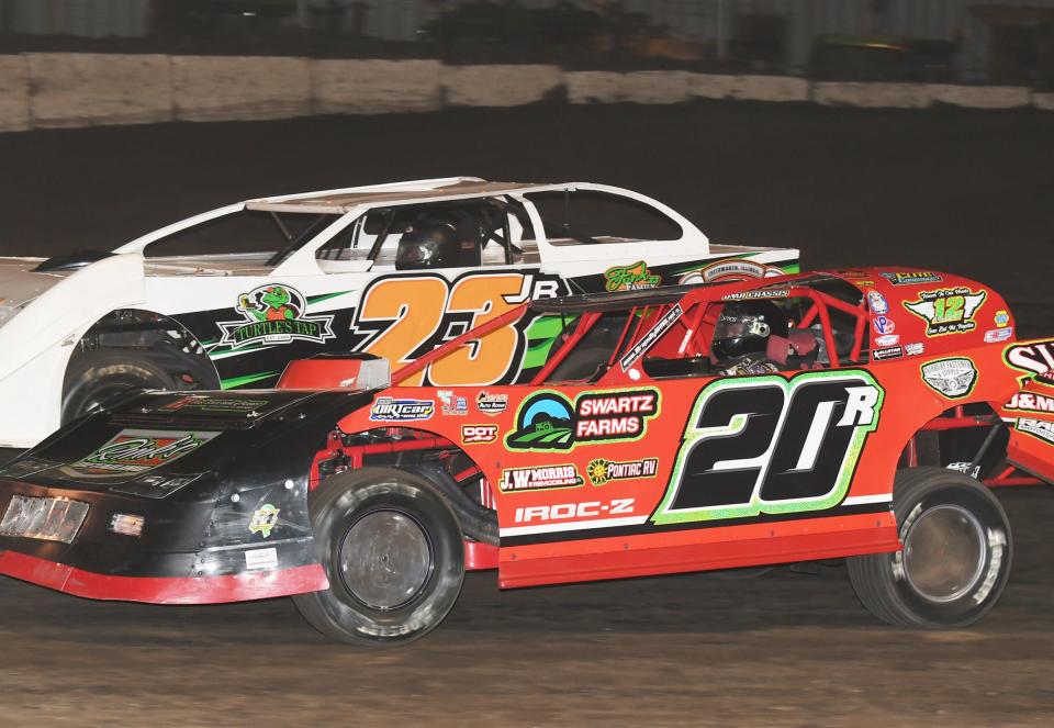 Tyler Roth (20) and Joel Funk (23) race for position last week at Fairbury Speedway. Funk, the winningest sportsman driver at Fairbury, and Roth, always a top runner, will look to knock off Tommy Duncan from his winning ways this Saturday night at "America's Dirt Track."