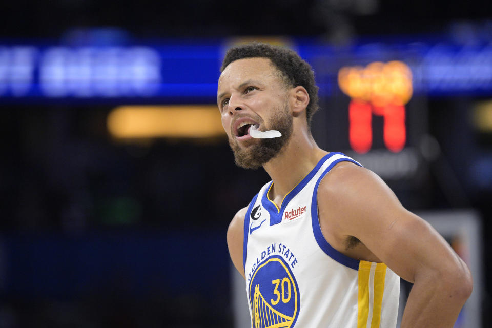 Golden State Warriors guard Stephen Curry reacts after being fouled during the first half of the team's NBA basketball game against the Orlando Magic, Thursday, Nov. 3, 2022, in Orlando, Fla. (AP Photo/Phelan M. Ebenhack)