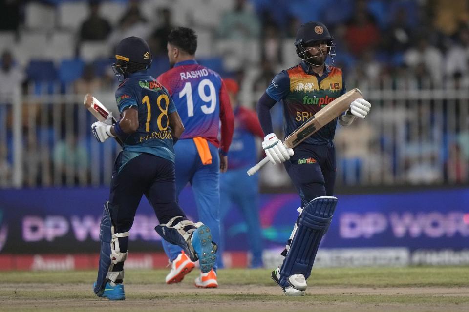 Sri Lanka's Kusal Mendis, right, and Pathum Nissanka run between the wickets during the T20 cricket match of Asia Cup between Sri Lanka and Afghanistan, in Sharjah, United Arab Emirates, Saturday, Sept. 3, 2022. (AP Photo/Anjum Naveed)