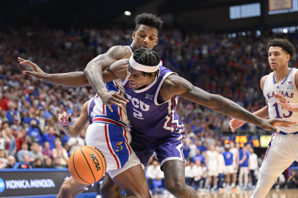 Kansas forward K.J. Adams Jr., top left, fouls TCU forward Emanuel Miller (2) during the second half of an NCAA college basketball game in Lawrence, Kan., Saturday, Jan. 6, 2024. (AP Photo/Reed Hoffmann)