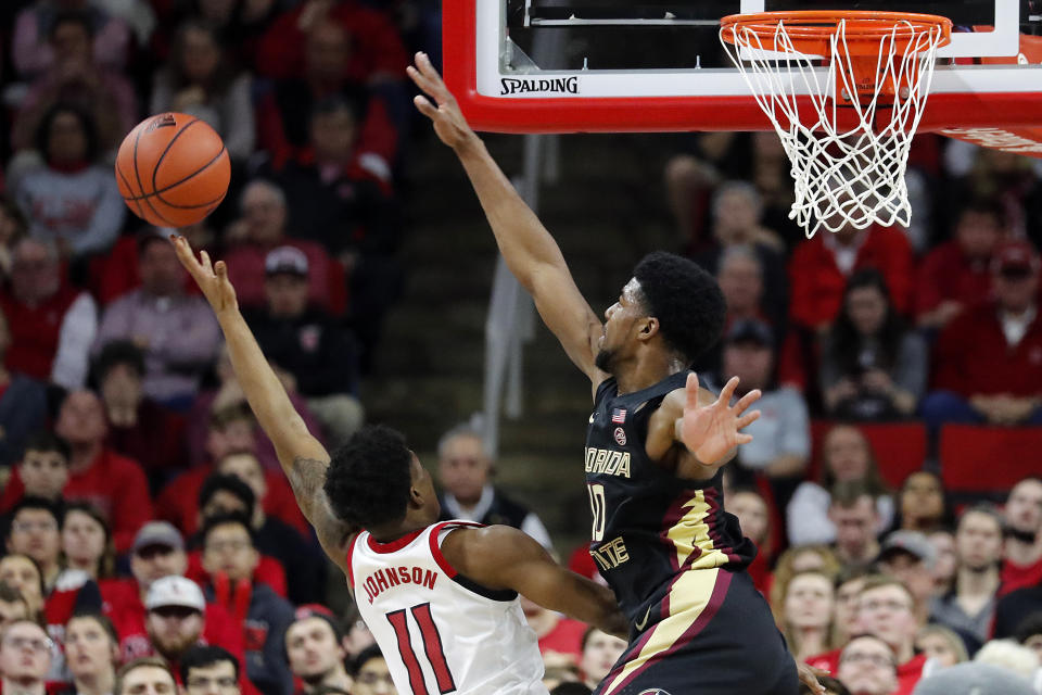 Florida State's Malik Osborne (10) goes up to block the shot of North Carolina State's Markell Johnson (11) during the second half of an NCAA college basketball game in Raleigh, N.C., Saturday, Feb. 22, 2020. (AP Photo/Karl B DeBlaker)