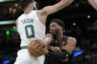 Cleveland Cavaliers guard Donovan Mitchell (45) tries to pass the ball around Boston Celtics forward Jayson Tatum (0) during the second half of Game 2 of an NBA basketball second-round playoff series Thursday, May 9, 2024, in Boston. (AP Photo/Steven Senne)