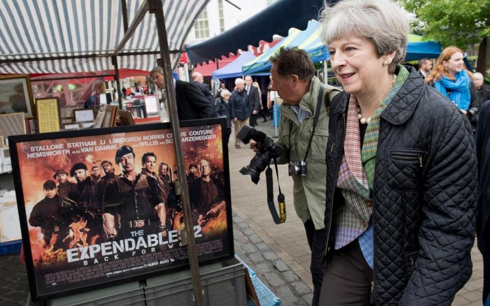 Theresa May walks past a stall selling film memorabilia at Abingdon Market on Monday - Credit: WPA Pool/Getty Images Europe