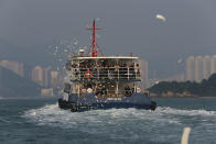 Relatives of victims who died in Monday's ferry collision throw paper money to pay tribute to those lost, Thursday, Oct. 4, 2012, in Hong Kong. A show of concern by Beijing over the boat collision that killed dozens of people in Hong Kong this week has backfired, further damaging the communist government's image in the former British colony. (AP Photo/Kin Cheung)