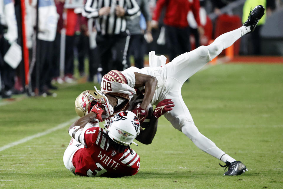North Carolina State's Aydan White (3) tackles Florida State's Ontaria Wilson (80) following a catch during the first half of an NCAA college football game in Raleigh, N.C., Saturday, Oct. 8, 2022. (AP Photo/Karl B DeBlaker)