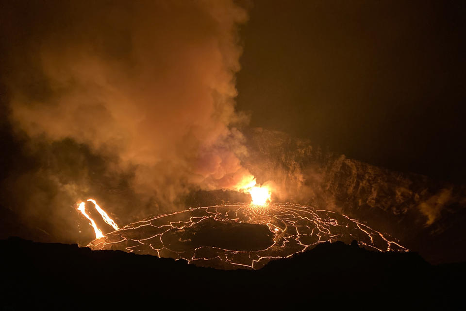 In this photo provided by the U.S. Geological Survey, a lava lake continues its rise in the crater of Hawaii's Kilauea volcano on Wednesday, Dec. 23, 2020. Lava is rising more than 3 feet per hour in the deep crater of a Hawaii volcano that began erupting over the weekend. The U.S. Geological Survey says Kilauea volcano within Hawaii Volcanoes National Park on the Big Island was gushing molten rock from at least two vents inside its summit crater. (H. Dietterich/U.S. Geological Survey via AP)