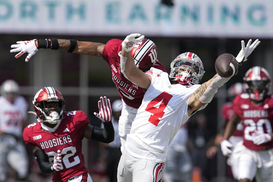 Indiana defensive back Nic Toomer, center left, breaks up a pass intended for Ohio State wide receiver Julian Fleming (4) during the first half of an NCAA college football game, Saturday, Sept. 2, 2023, in Bloomington, Ind. (AP Photo/Darron Cummings)