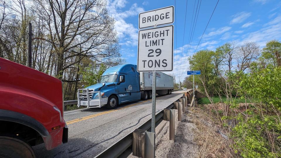 Two tractor trailers cross over the Little Conewago Creek along Canal Road on April 25, which is restricted to a 29 ton weight limit. Canal Road is now a major access route to the Susquehanna Trail and on to Interstate 83.