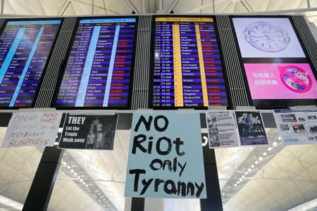 An information screen showing cancelled flights is pictured at Hong Kong International Airport as anti-extradition bill protesters attend a mass demonstration after a woman was shot in the eye during a protest in Hong Kong