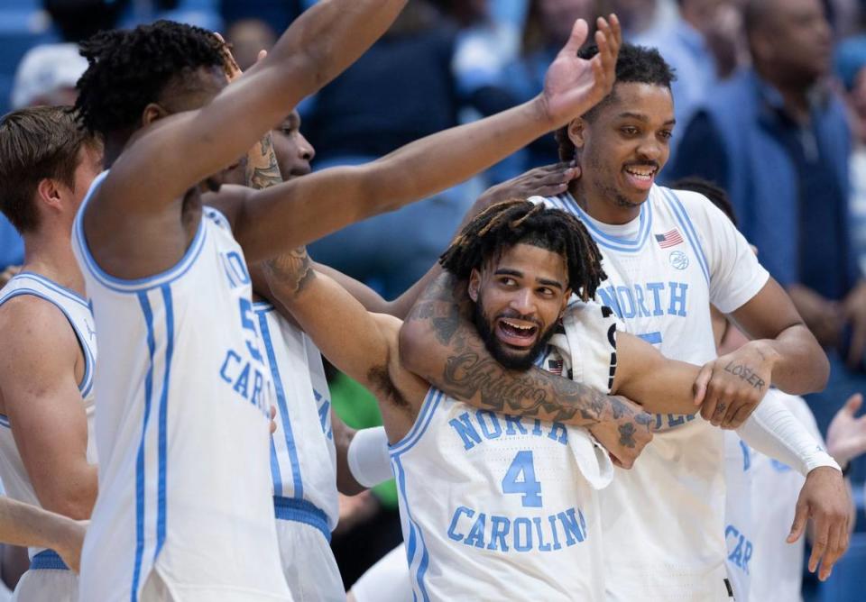 North Carolina’s Armando Bacot (5) embraces R.J. Davis (4) as they celebrate their 103-67 victory over Syracuse on Jan. 13 at the Smith Center in Chapel Hill.