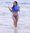 <p>Dressed in SKIMS swimwear, Kim Kardashian playfully poses during a photoshoot on Jan. 18.</p>