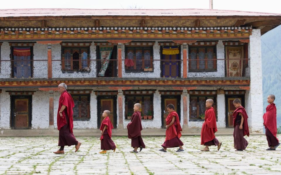 Bhutan, Bumthang, Karchu Dratsang Monastery, Buddhist Lama and monks - Getty