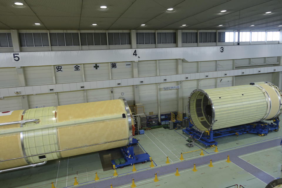 This shows the first stage, left, and the second stage, right, in final preparations for an upcoming H3 rocket flight later this year, inside the Mitsubishi Heavy Industries’ Nagoya Aerospace Systems Works Tobishima Plant in Tobishima, Aichi prefecture Thursday, March 21, 2024. (AP Photo/Mari Yamaguchi)