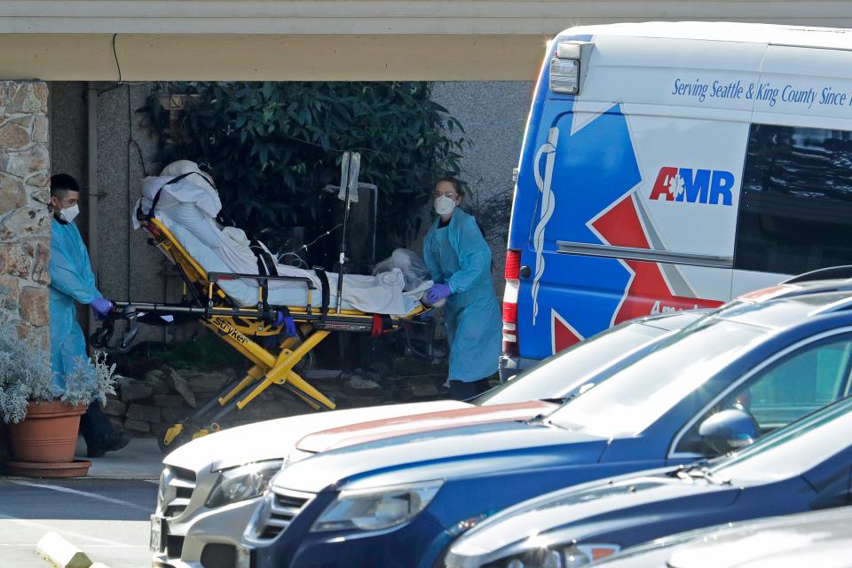 A patient is loaded into an ambulance at the Life Care Center in Kirkland, Wash. Monday, March 9, 2020, near Seattle. The nursing home is at the center of the outbreak of the COVID-19 coronavirus in Washington state.