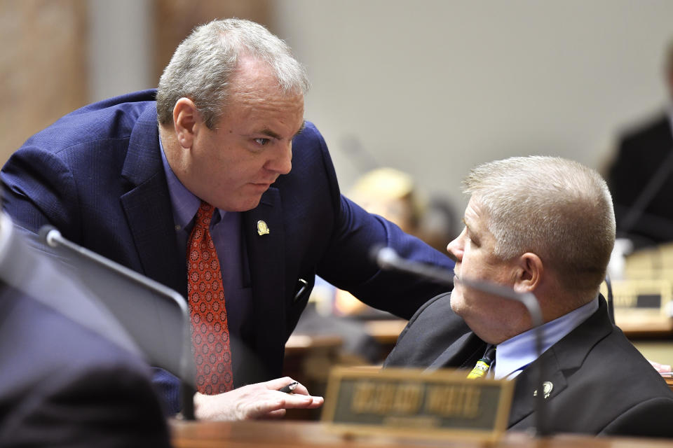 Kentucky Rep. Jason Nemes, left, talks with Rep. Timothy D. Truett during the session in the House chamber of the Kentucky State Capitol in Frankfort, Ky., Wednesday, March 29, 2023. (AP Photo/Timothy D. Easley)