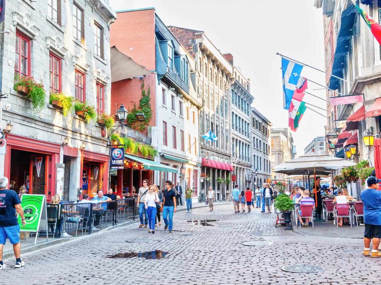 people walking down a street in old montreal