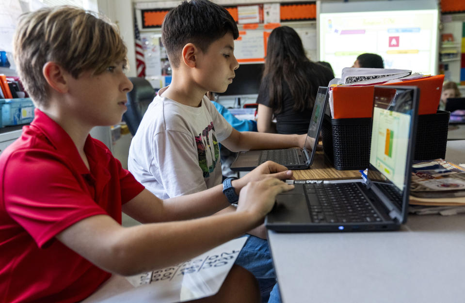 Fifth grade students work on computers during a math class at Mount Vernon Community School, in Alexandria, Va., Wednesday, May 1, 2024. (AP Photo/Jacquelyn Martin)