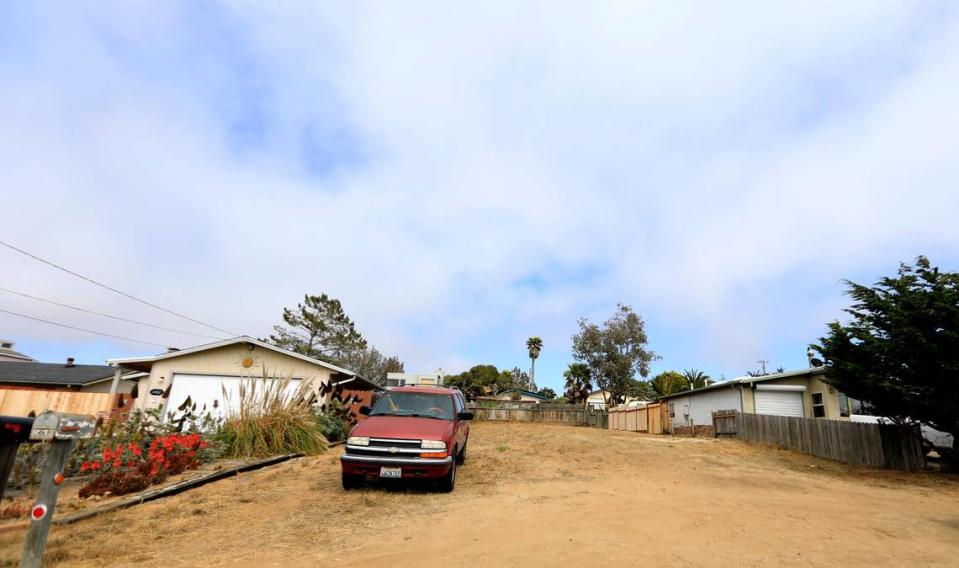 A car parks on an empty lot at the 1400 block of 12th Street in Los Osos. Empty lots like this are scattered all over town with property owners unable to build amid a long-running moratorium that may finally be coming to an end.