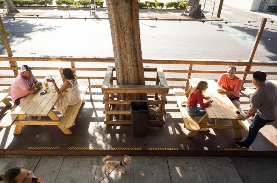 Peter and Samara Palko, left, sit at a table opposite Annelise Spargo, Chris Ryan and Daelon Arriola in Kupros Craft House’s outdoor parklet Friday, May 12, on 21st Street.“It’s just nice to be outside, especially when the weather’s nice,” Spargo said.