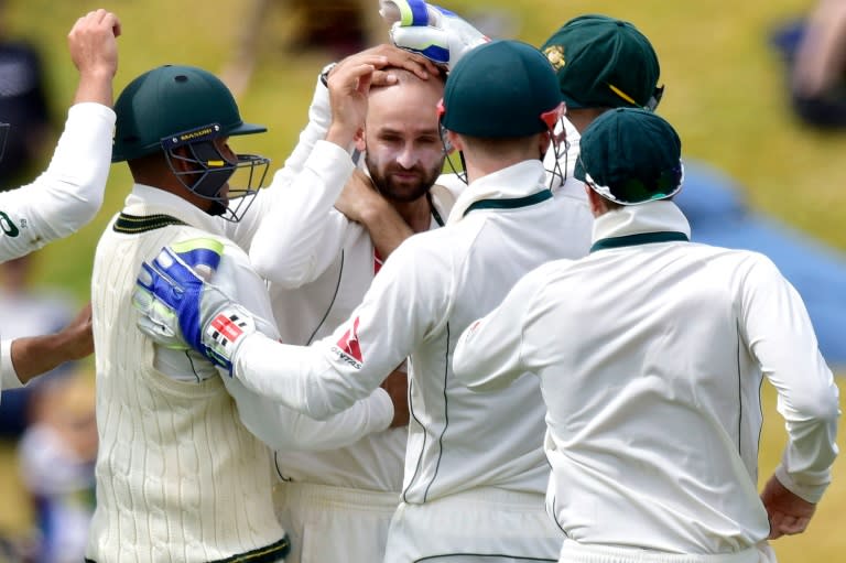 Australia's Nathan Lyon (C) celebrates with teammates after New Zealand's BJ Watling is bowled during day four of the first Test in Wellington on February 15, 2016