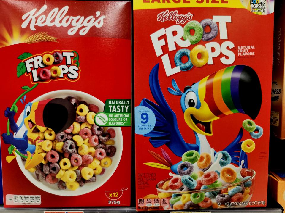 The non-US box's Loops are less pastel and varied (light yellow and shades of red and purple) than the US label (with green, blue, orange, purple, yellow, and red)