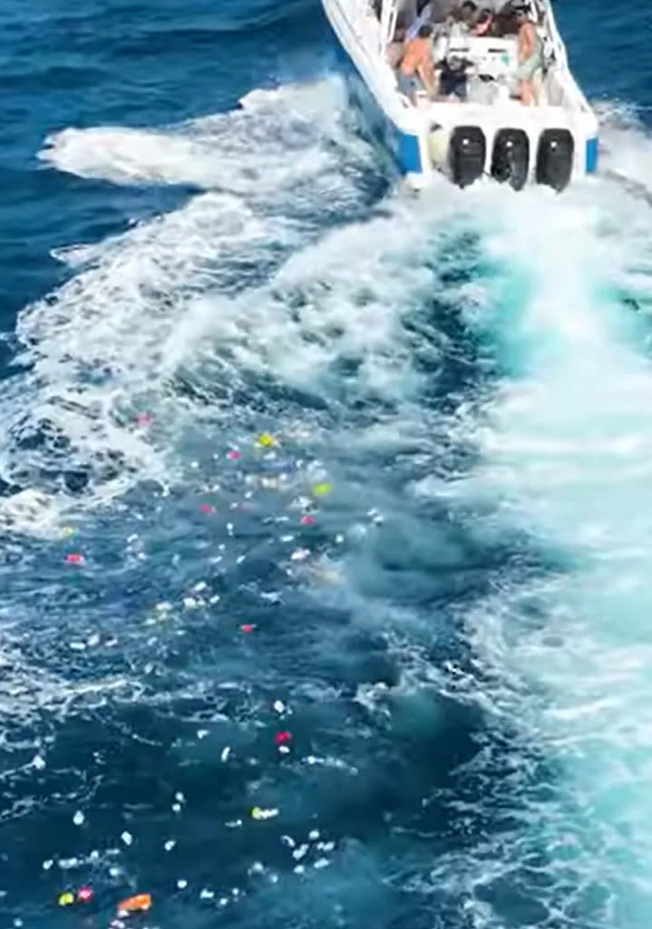 A trail of trash is behind the boat after Boca Bash partiers dumped bins of garbage in the Atlantic.