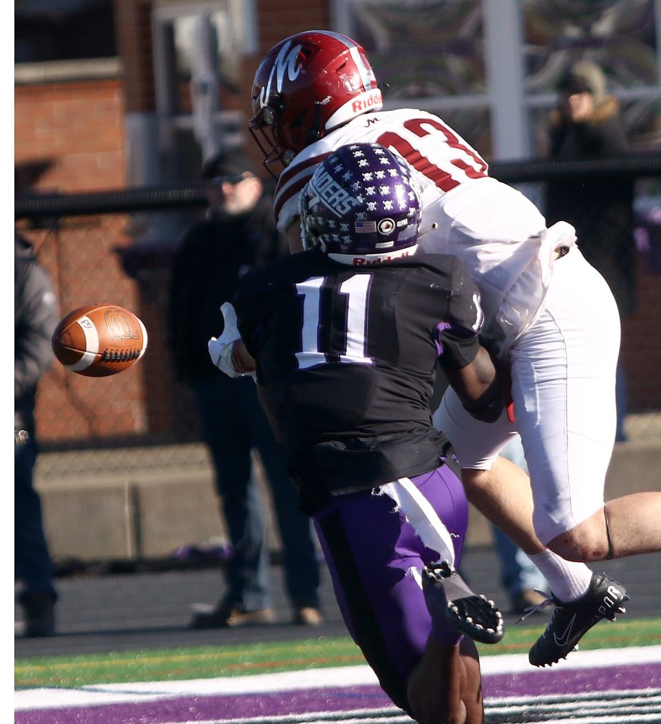 Mount Union defender Jalen Griffin (11) breaks up a fourth-down pass to Muhlenberg's Michael Feaster during their quarterfinal playoff game against Muhlenberg, Saturday, December 4, 2021