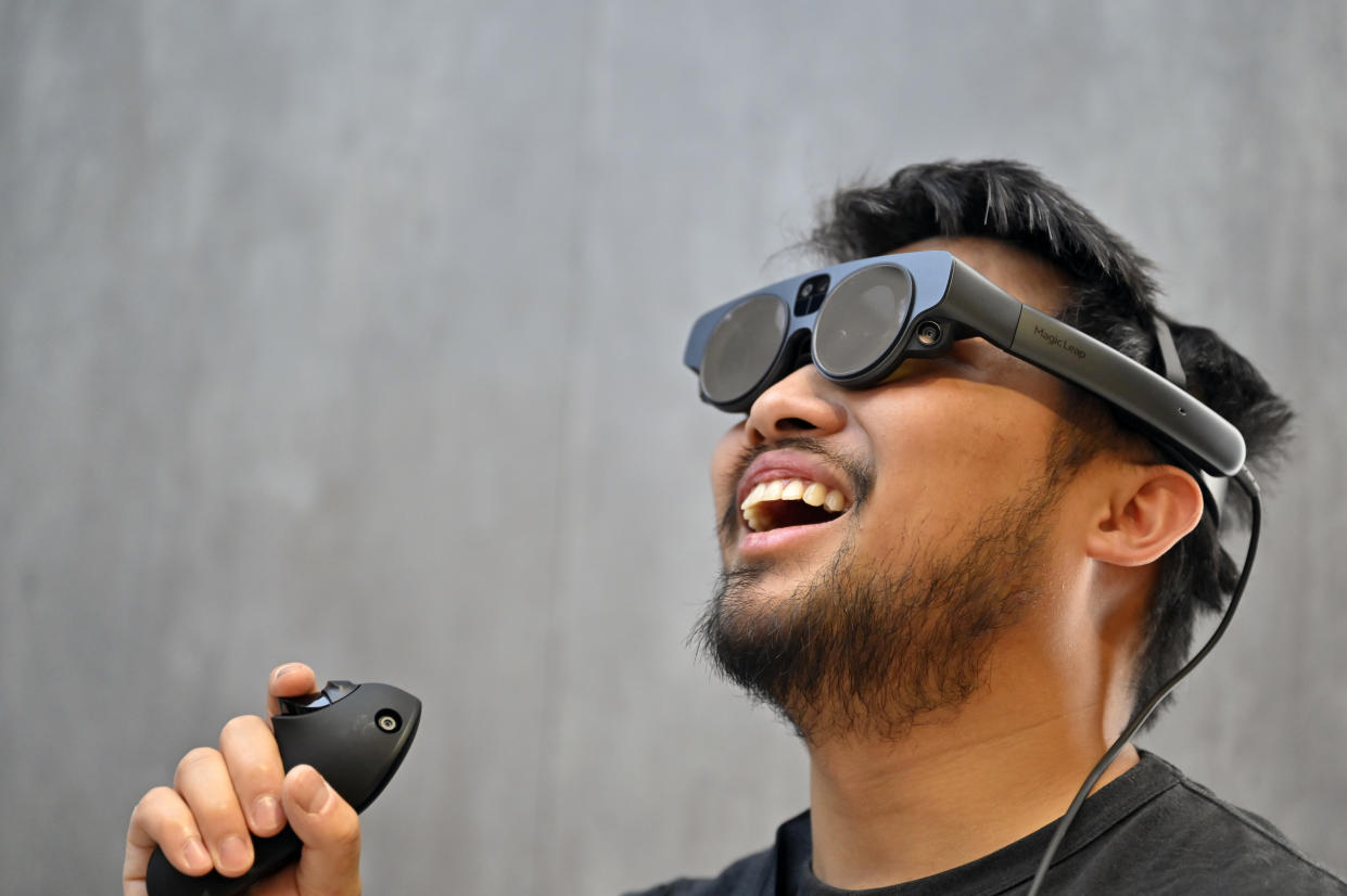 LAS VEGAS, NEVADA - JANUARY 06: Attendee Jason Nguyen uses augmented reality (AR) glasses in a simulation at the Magic Leap booth during CES 2023 at the Las Vegas Convention Center on January 6, 2023 in Las Vegas, Nevada. CES, the world's largest annual consumer technology trade show, runs through January 08 and features about 3,200 exhibitors showing off their latest products and services to more than 100,000 attendees. (Photo by David Becker/Getty Images)