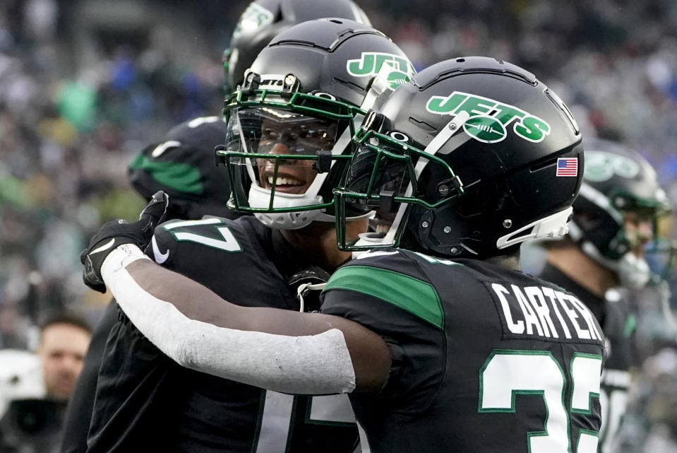 New York Jets wide receiver Garrett Wilson, left, celebrates with running back Michael Carter (32) after scoring a touchdown against the Chicago Bears during the first quarter of an NFL football game, Sunday, Nov. 27, 2022, in East Rutherford, N.J. (AP Photo/John Minchillo)