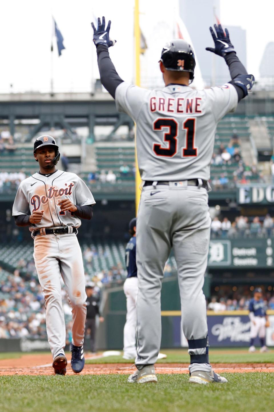 Brendon Davis (74) of the Detroit Tigers scores a run as Riley Greene (31) waits for him during the fifth inning of the game against the Seattle Mariners at T-Mobile Park on October 05, 2022 in Seattle.
