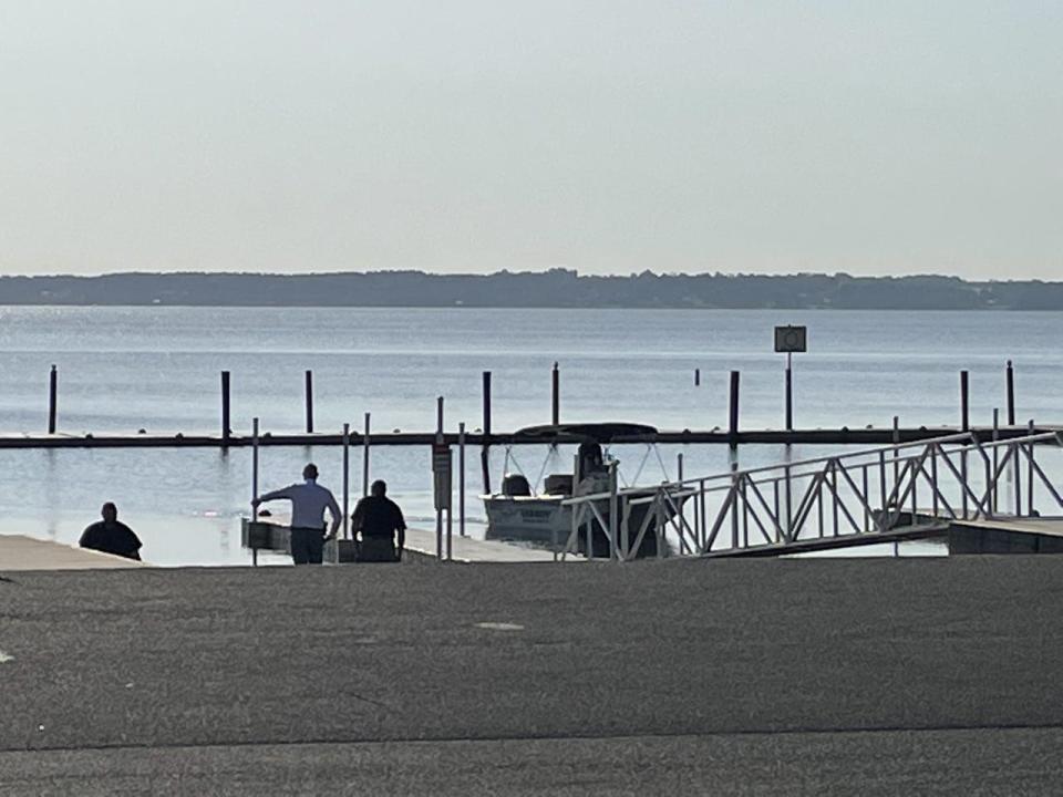 This was the scene on the shore of Lake Weir on Thursday after divers recovered the body of a man who went missing Tuesday.