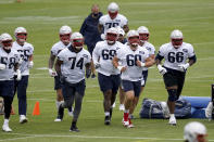 New England Patriots center David Andrews (60) leads his teammates across a field during NFL football practice in Foxborough, Mass., Friday, June 4, 2021. (AP Photo/Mary Schwalm)