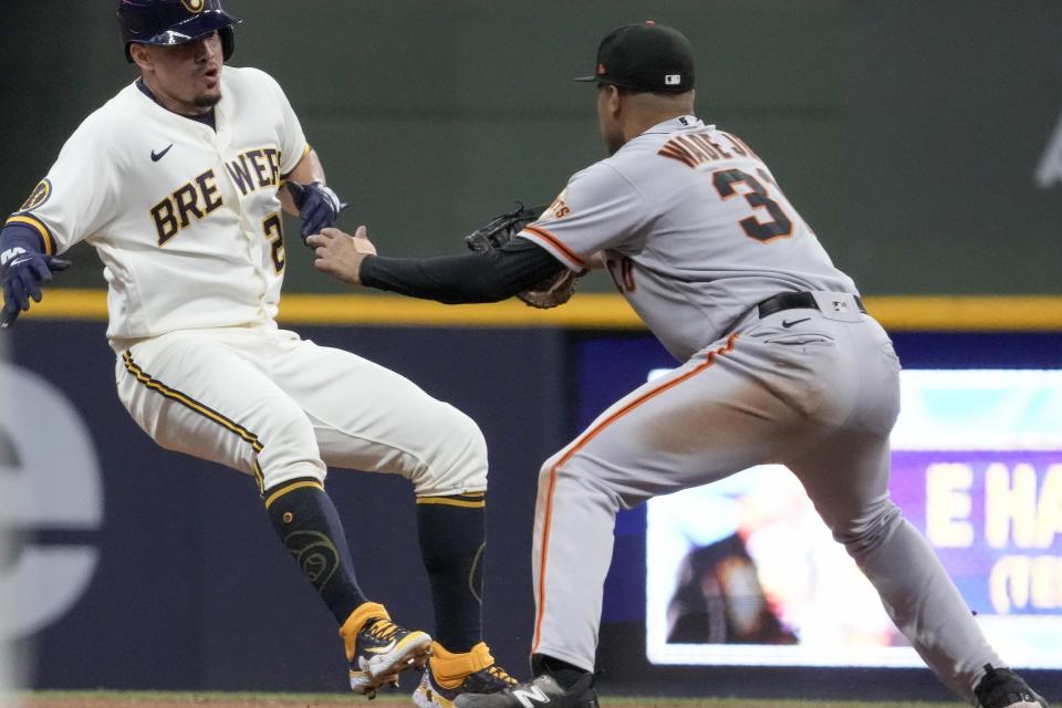 San Francisco Giants' LaMonte Wade Jr. tags out Milwaukee Brewers' Willy Adames after bring caught in a run down during the fourth inning of a baseball game Thursday, May 25, 2023, in Milwaukee. (AP Photo/Morry Gash)