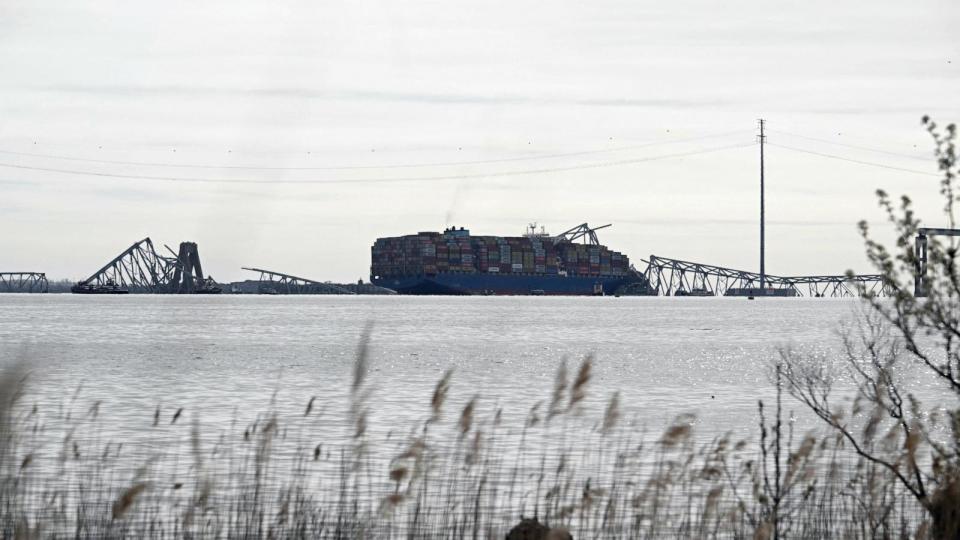 PHOTO: The steel frame of the Francis Scott Key Bridge sits on top of the container ship Dali after the bridge collapsed, Baltimore, March 26, 2024. (Mandel Ngan/AFP via Getty Images)