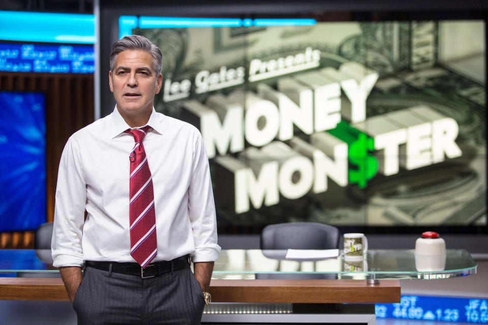 George Clooney stands in front of his news desk