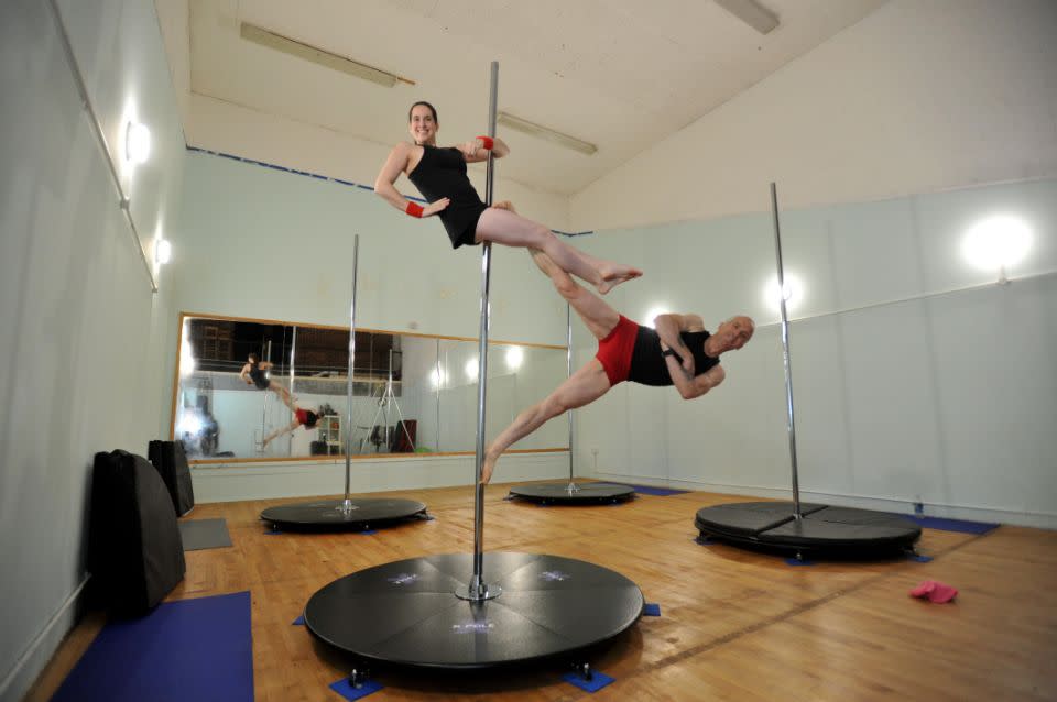 The pair started off pole dancing separately, but were soon drawn together. Photo: SWNS