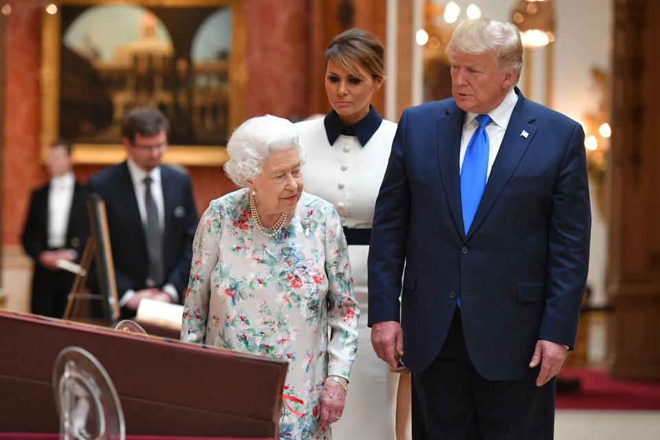 Britain's Queen Elizabeth II (L) views a display of US items of the Royal collection with US President Donald Trump and US First Lady Melania Trump at Buckingham palace at Buckingham Palace in central London on June 3, 2019, on the first day of their three-day State Visit to the UK. - Britain rolled out the red carpet for US President Donald Trump on June 3 as he arrived in Britain for a state visit already overshadowed by his outspoken remarks on Brexit. (Photo by MANDEL NGAN / AFP)        (Photo credit should read MANDEL NGAN/AFP/Getty Images)