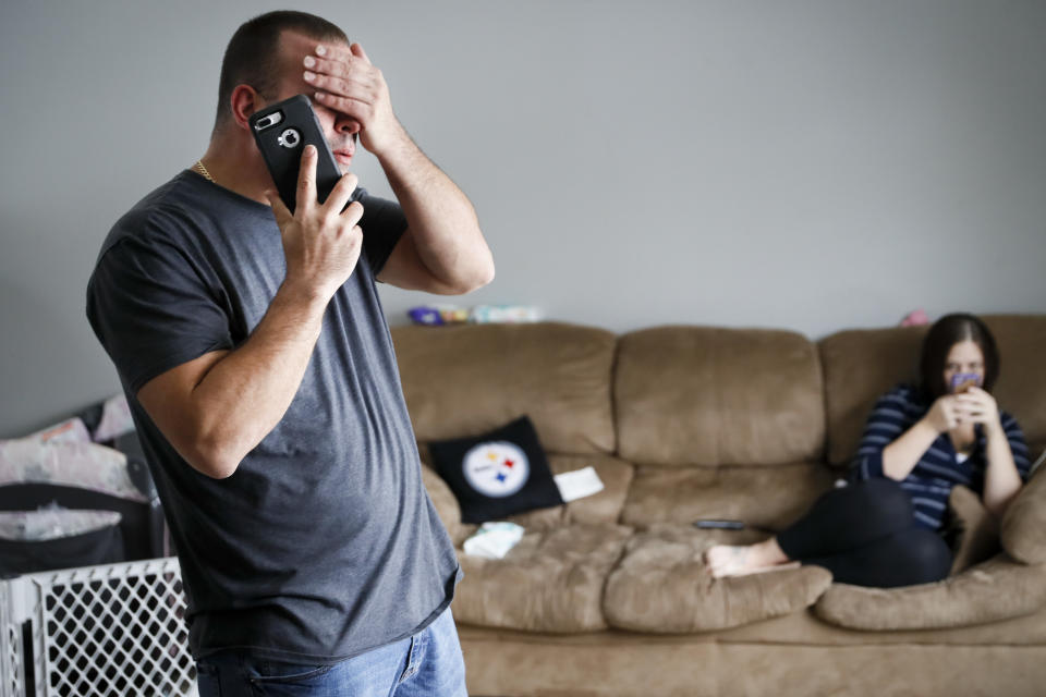 Tom Wolikow, a General Motors employee who is currently laid-off, left, takes a phone call at home alongside his fiance Rochelle Carlisle, right, Wednesday, Nov. 28, 2018, in Warren, Ohio. The GM closure would have a ripple effect. (Photo: AP/John Minchillo)