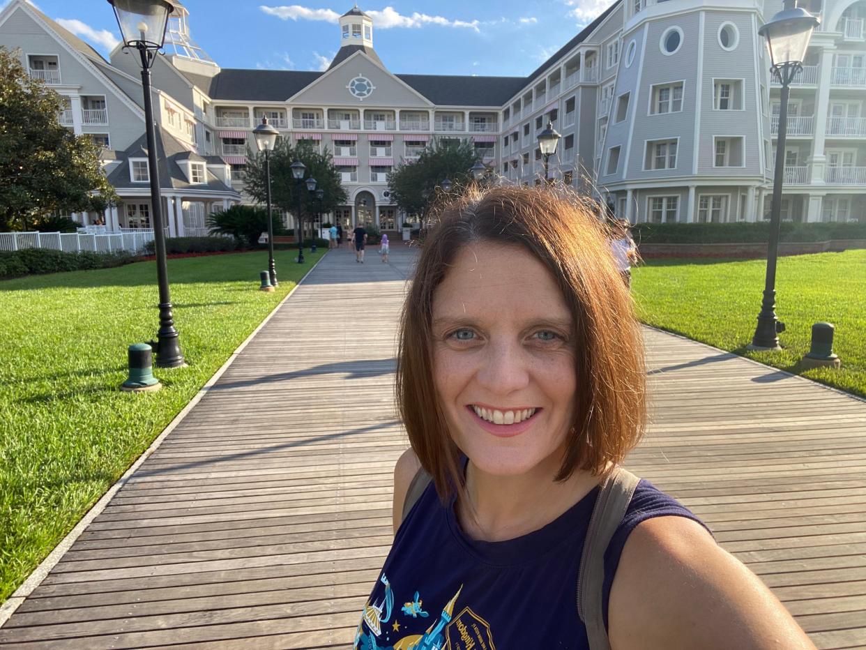 selfie of kari standing outside the disney yacht club resort